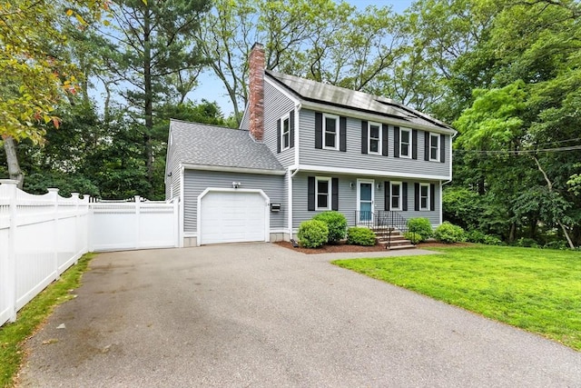 6 Flagg Dr, Framingham, MA 01702 - colonial home with an attached garage, a chimney, driveway, and a shingled roof