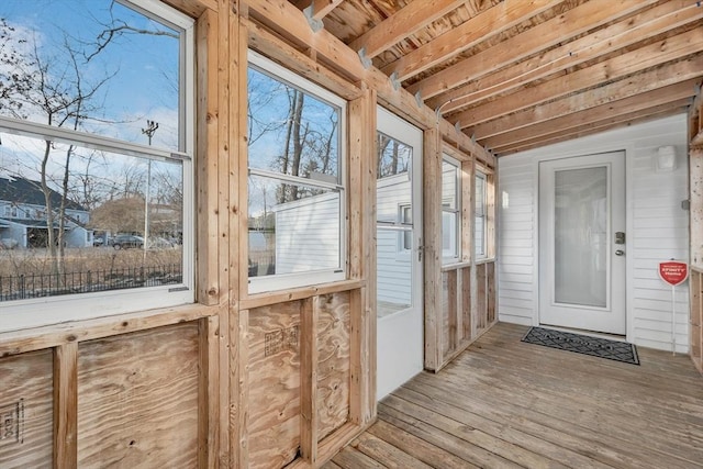 unfurnished sunroom featuring lofted ceiling