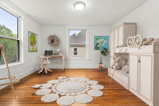 living area with wood finished floors and baseboards