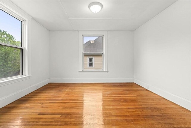 unfurnished room with wood finished floors and baseboards