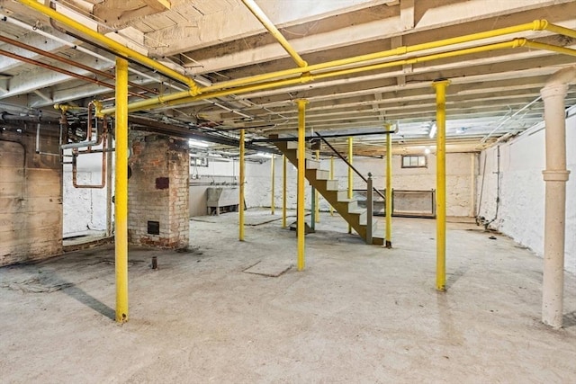 unfinished basement featuring stairs