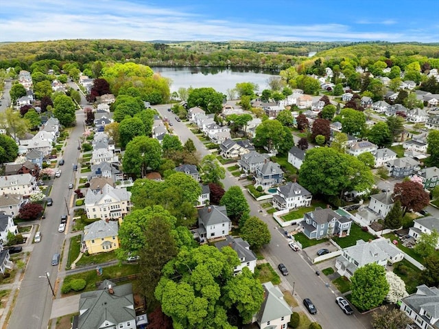 aerial view of property's location with a large body of water and nearby suburban area