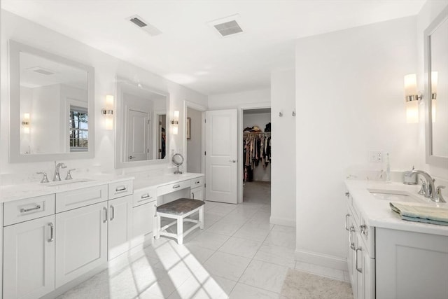 bathroom featuring visible vents, baseboards, marble finish floor, and vanity