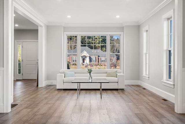 unfurnished room featuring baseboards, wood finished floors, and crown molding