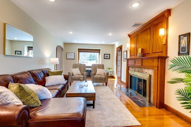 living room with a fireplace and light hardwood / wood-style floors