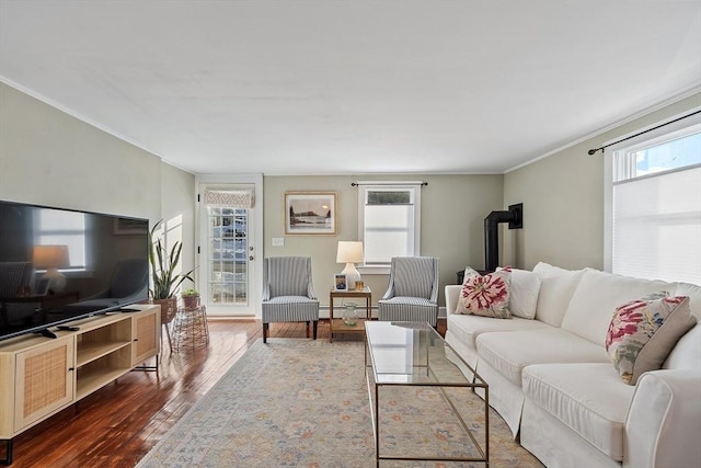 living room featuring crown molding, baseboard heating, and dark hardwood / wood-style flooring