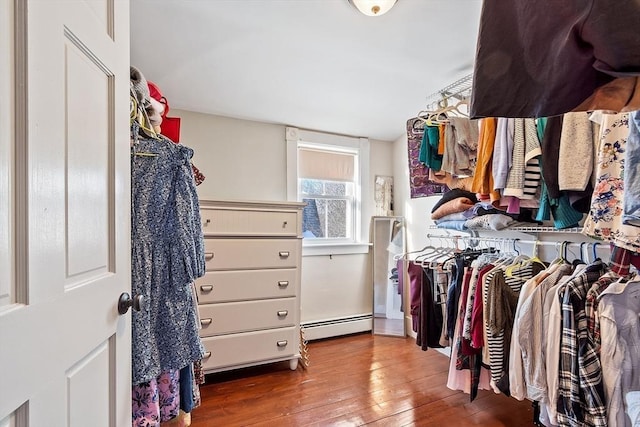 walk in closet featuring baseboard heating and wood-type flooring