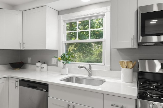 235 Groton Rd, Chelmsford, MA 01863 - kitchen featuring appliances with stainless steel finishes, a sink, white cabinets, and light stone counters