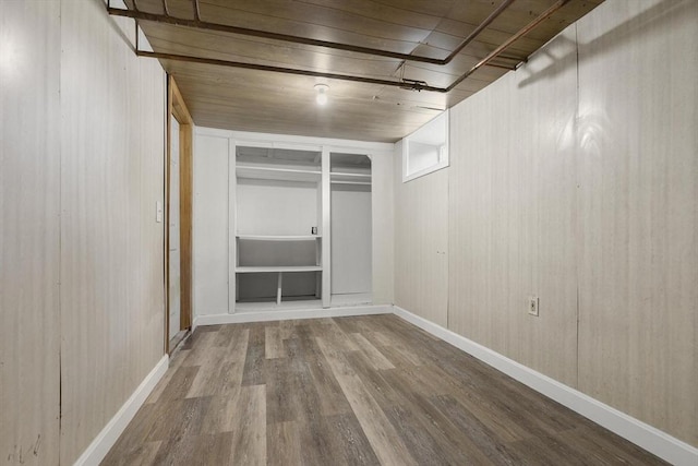 235 Groton Rd, Chelmsford, MA 01863 - empty room with wood finished floors, baseboards, built in shelves, and wood walls