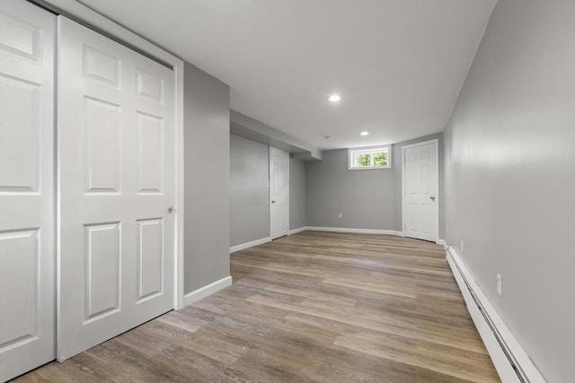 235 Groton Rd, Chelmsford, MA 01863 - below grade area with a baseboard radiator, baseboards, light wood-type flooring, and recessed lighting