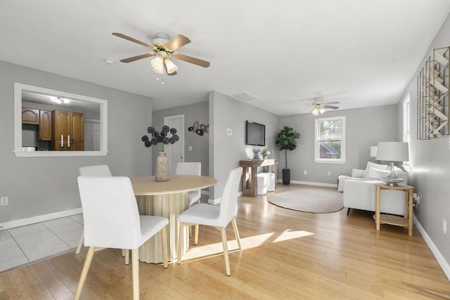 235 Groton Rd, Chelmsford, MA 01863 - dining room featuring a ceiling fan, light wood-style floors, and baseboards