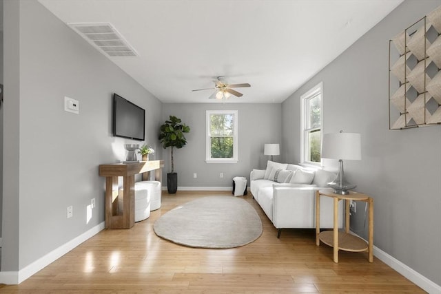 235 Groton Rd, Chelmsford, MA 01863 - living area with ceiling fan, light wood-style floors, and baseboards