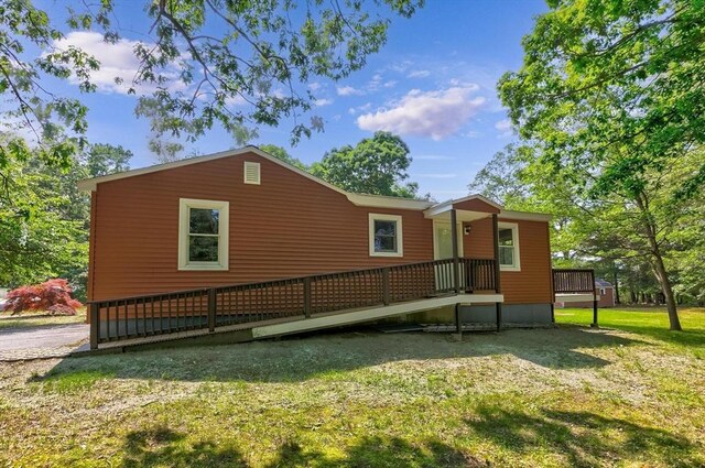 235 Groton Rd, Chelmsford, MA 01863 - view of side of property featuring a yard and a wooden deck