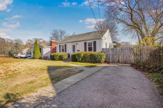 bungalow-style home featuring a front lawn