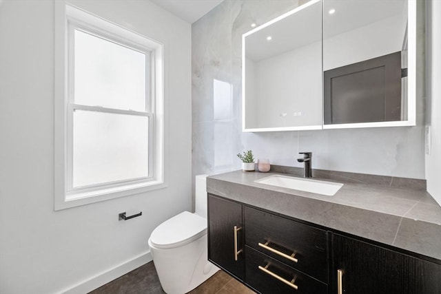 bathroom featuring vanity, tile patterned floors, and toilet