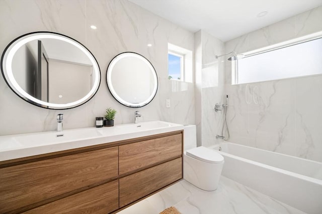 full bathroom featuring tiled shower / bath, vanity, and toilet