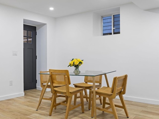 dining space with light hardwood / wood-style flooring