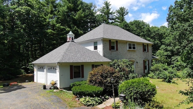 217 Grove St, Paxton, MA 01612 - view of front of home featuring roof with shingles, a garage, and driveway