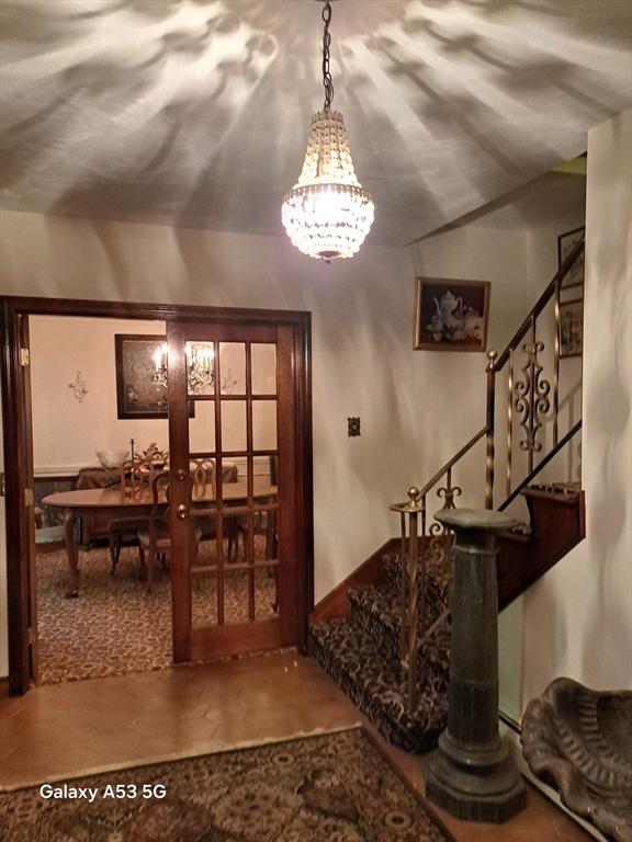 217 Grove St, Paxton, MA 01612 - entrance foyer featuring stairs and a chandelier