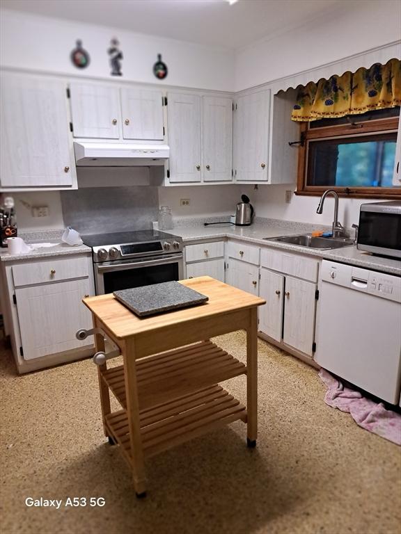217 Grove St, Paxton, MA 01612 - kitchen featuring stainless steel appliances, under cabinet range hood, a sink, light countertops, and white cabinets