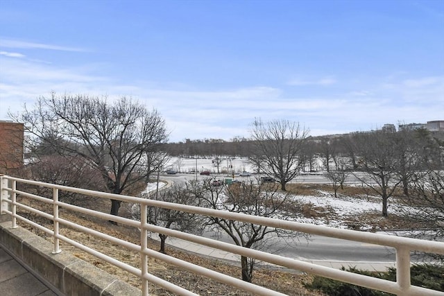 view of snow covered back of property