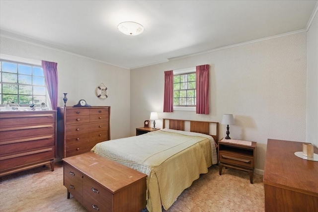 bedroom featuring crown molding and light carpet