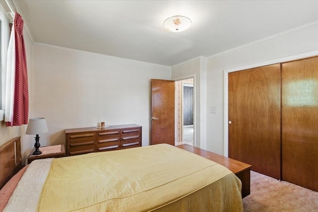 bedroom featuring a closet, ornamental molding, and carpet flooring