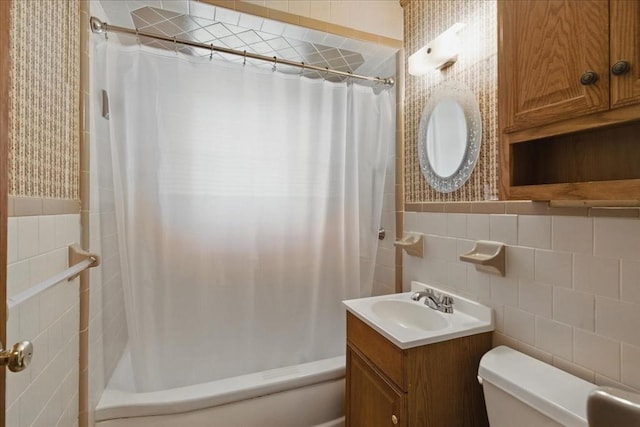 full bath with vanity, tile walls, shower / bath combo, and toilet