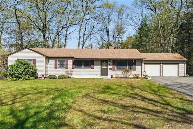 ranch-style house with aphalt driveway, a chimney, a front yard, and a garage