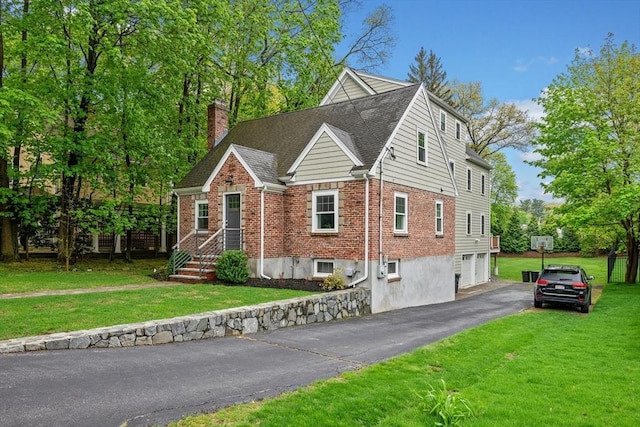 26 Downing Rd, Lexington, MA 02421 - view of front of house with asphalt driveway, brick siding, a chimney, and a front lawn