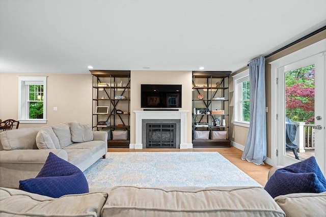 26 Downing Rd, Lexington, MA 02421 - living room with light wood finished floors, a fireplace, baseboards, and recessed lighting