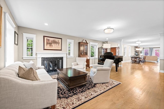 26 Downing Rd, Lexington, MA 02421 - living room with a fireplace, healthy amount of natural light, wood finished floors, recessed lighting, and baseboards