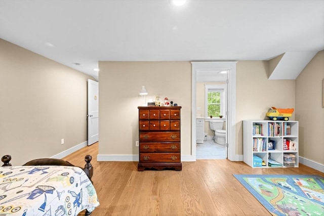 26 Downing Rd, Lexington, MA 02421 - bedroom featuring light wood-style flooring, baseboards, and connected bathroom
