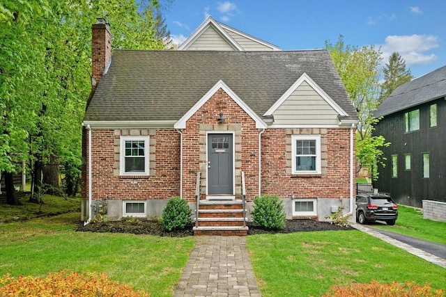 26 Downing Rd, Lexington, MA 02421 - view of front of home with brick siding, a chimney, a front lawn, entry steps, and roof with shingles