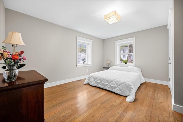 26 Downing Rd, Lexington, MA 02421 - bedroom featuring baseboards, multiple windows, and wood finished floors