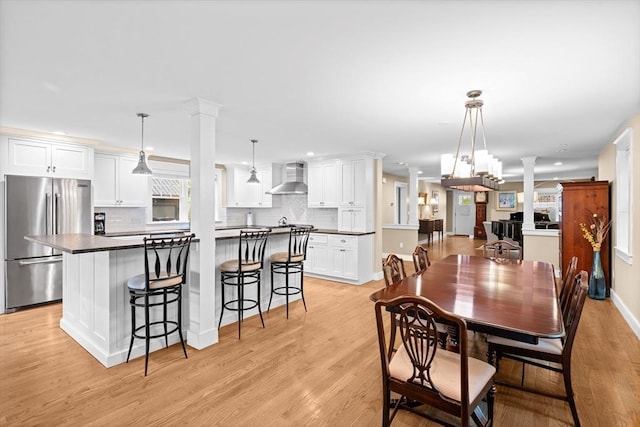 26 Downing Rd, Lexington, MA 02421 - dining space with ornate columns, light wood-style floors, and recessed lighting