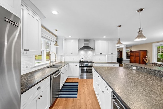 26 Downing Rd, Lexington, MA 02421 - kitchen featuring stainless steel appliances, a sink, wall chimney range hood, white cabinetry, and light wood finished floors