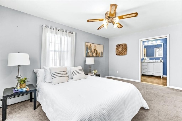 carpeted bedroom featuring ensuite bathroom, ceiling fan, and baseboard heating