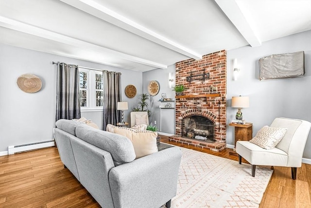 living room featuring hardwood / wood-style flooring, a baseboard radiator, a brick fireplace, and beam ceiling