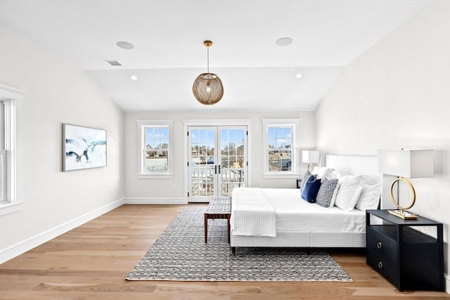 bedroom featuring vaulted ceiling, baseboards, light wood-style flooring, and access to exterior