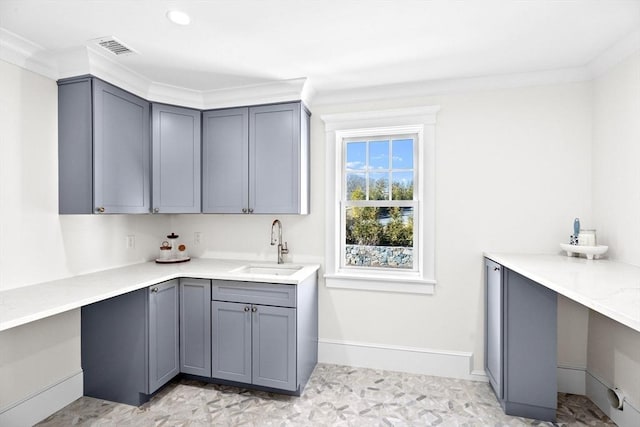 laundry area with baseboards, visible vents, and a sink