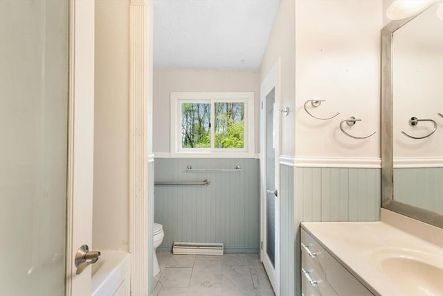 bathroom with marble finish floors, toilet, a wainscoted wall, vanity, and baseboard heating