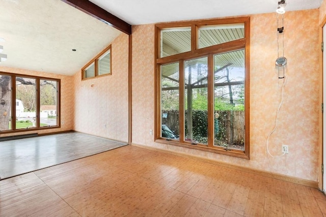unfurnished room with baseboards and wallpapered walls
