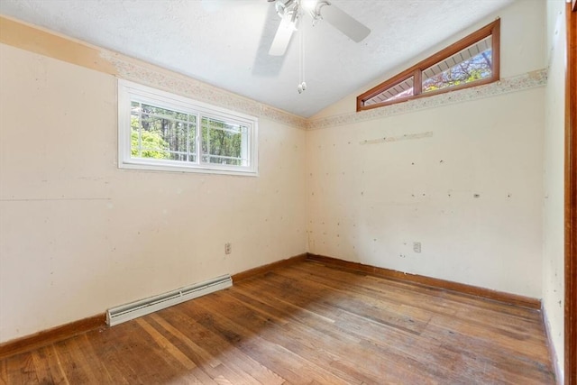 unfurnished room with a baseboard radiator, lofted ceiling, hardwood / wood-style floors, baseboards, and a ceiling fan