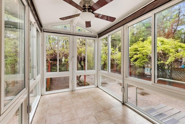 unfurnished sunroom with ceiling fan
