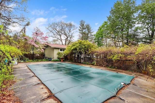 view of pool featuring a fenced backyard and an outbuilding
