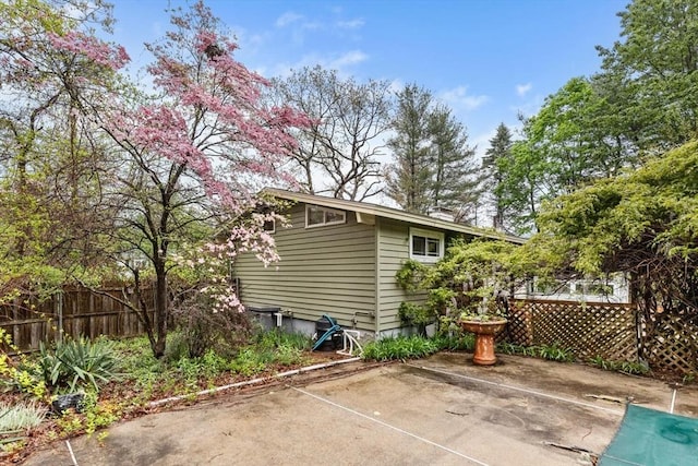 rear view of property featuring fence and a patio