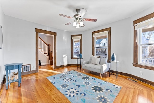 sitting room with wood-type flooring and ceiling fan