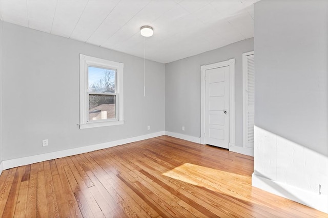 spare room with wood-type flooring