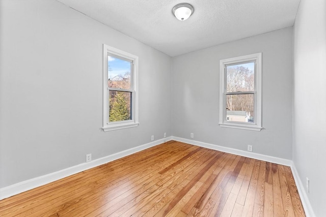 spare room with wood-type flooring and a textured ceiling